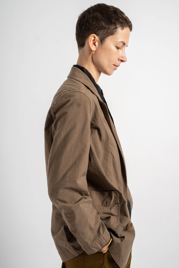 Person wearing a brown jacket on a white background