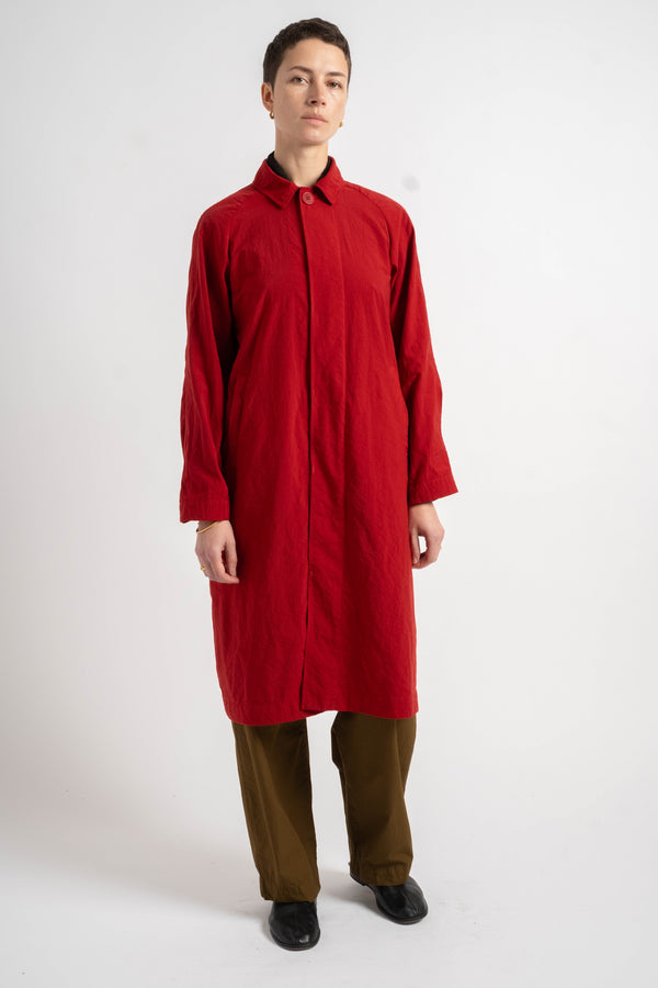 Person wearing a red coat on a white background