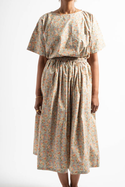 Woman wearing a floral dress on a white background