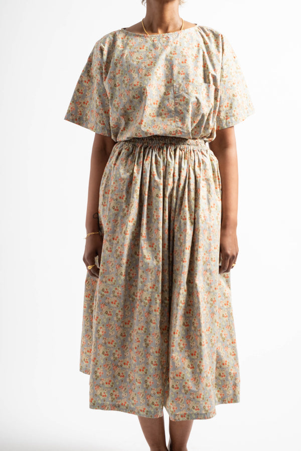 Woman wearing a floral dress on a white background