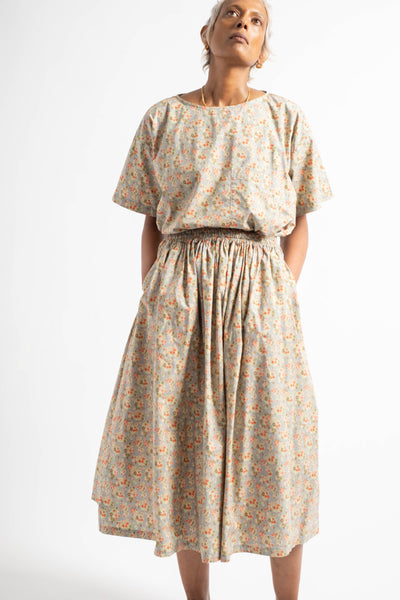 Woman wearing a floral dress on a white background