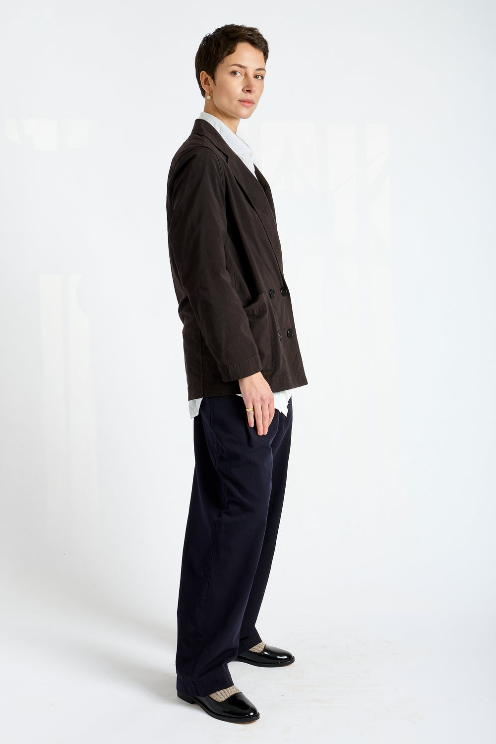 Person wearing a dark suit and white shirt on a white background